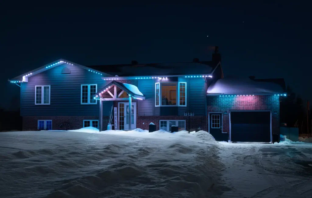 home in the snow lit up by Celebright holiday lighting system