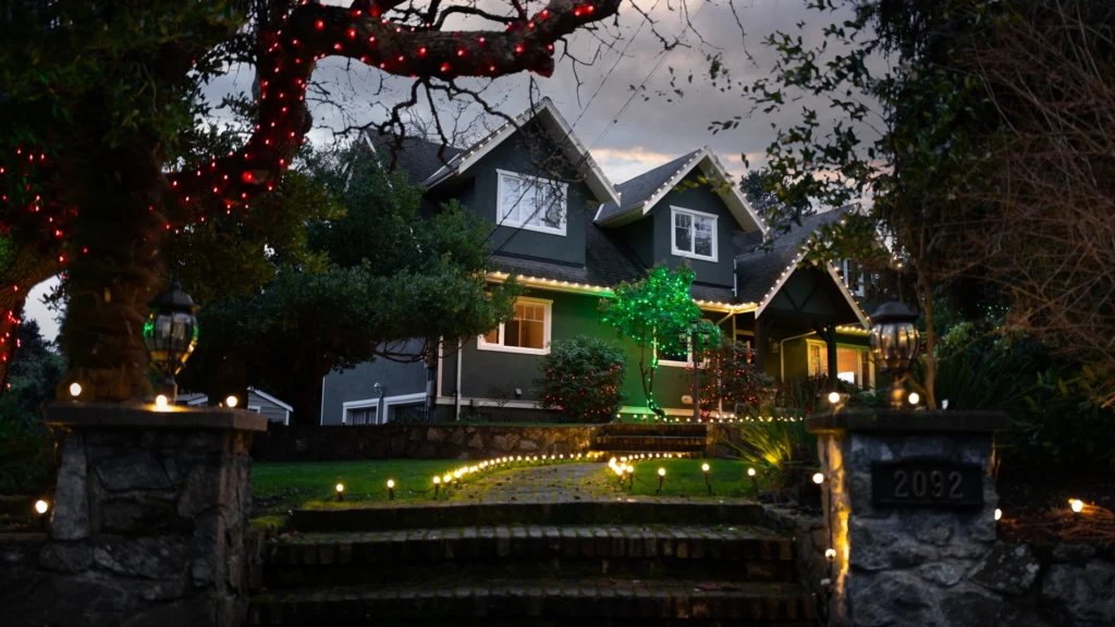 traditional holiday lighting installation on exterior of Victoria home