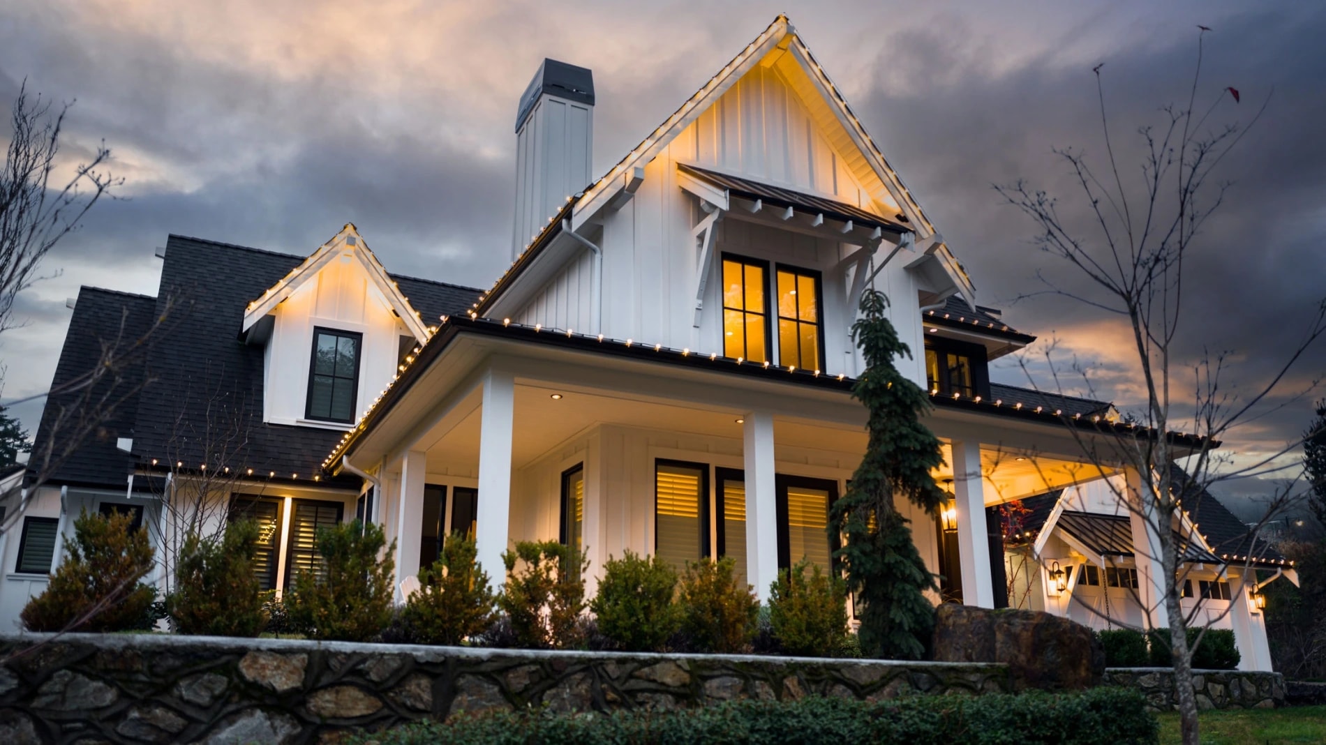 exterior of beautiful Victoria home lit up with white christmas lights