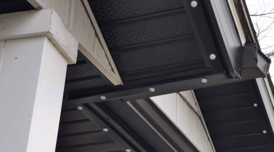 Standard black track for permanent christmas lights with lights installed on a home